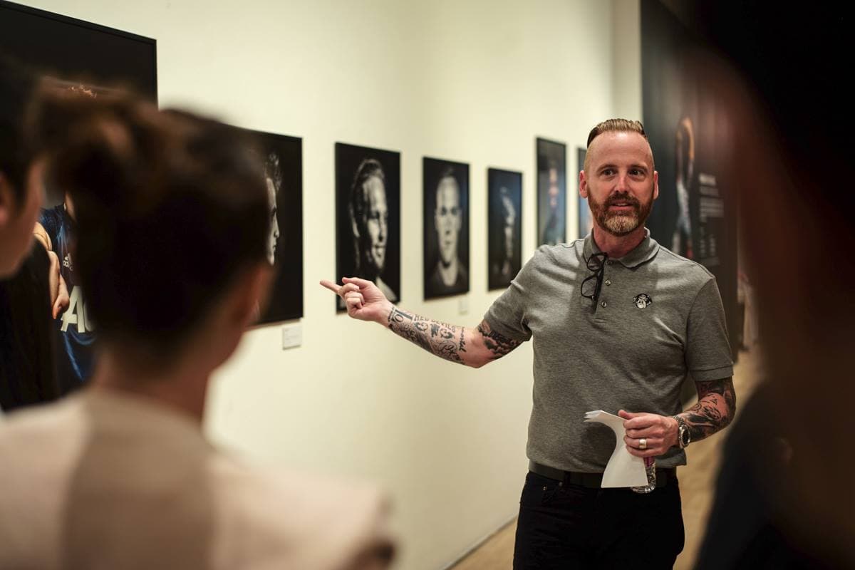 Eric pointing at photo in gallery